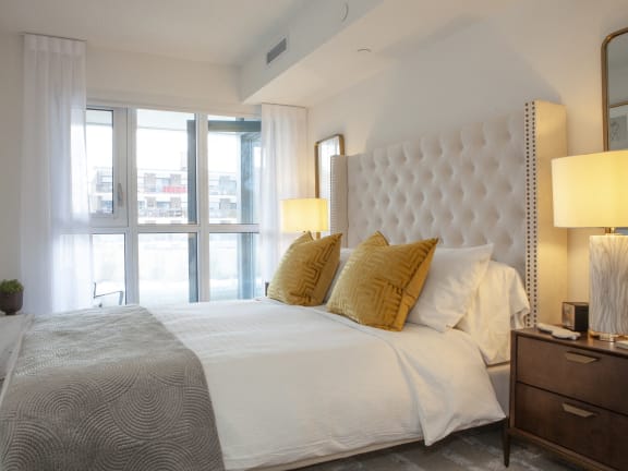 a bedroom with a large bed and a large window