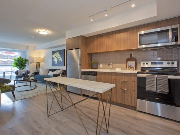 a kitchen with stainless steel appliances and a marble table