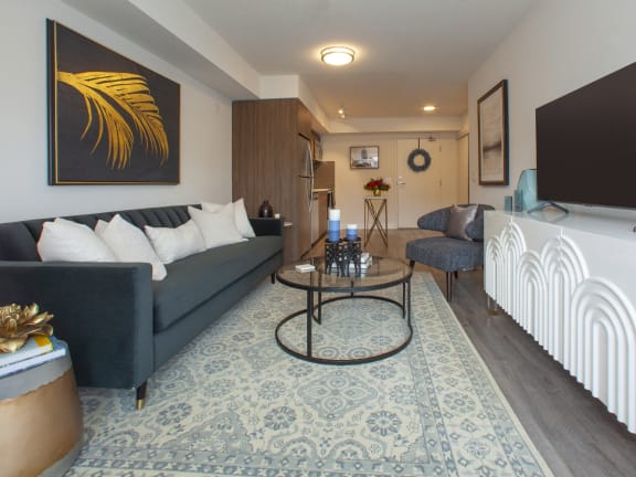 a living room with a blue couch and a tv