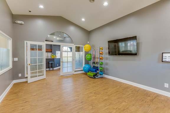 A room with wooden floors and a large window.