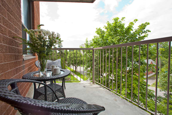 a balcony with a table and chairs on it