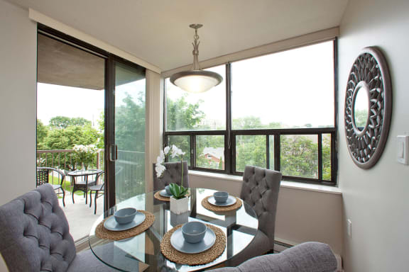 a living room with a table and chairs and a large window