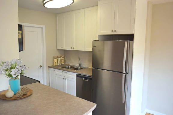 a kitchen with stainless steel appliances and white cabinets
