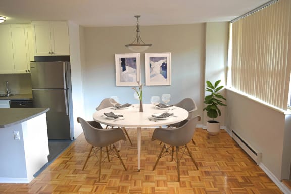 a dining room with a table and chairs and a kitchen