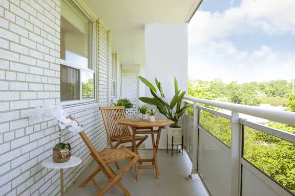 a patio with a table and chairs on a balcony