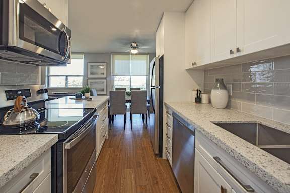 a kitchen with granite counter tops and stainless steel appliances