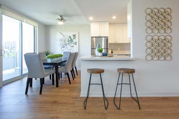 a kitchen and dining area with a table and stools