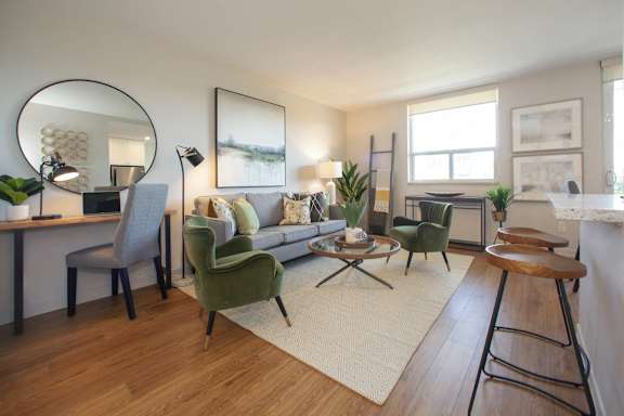 a living room with a couch and chairs and a table