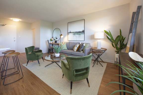 a living room with green chairs and a couch