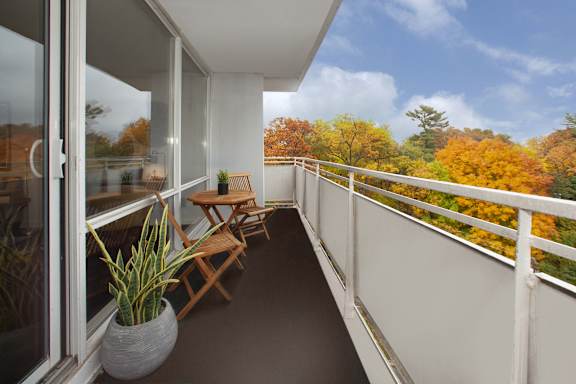 a balcony with a table and chairs on it