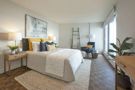 a bedroom with a large bed and a window