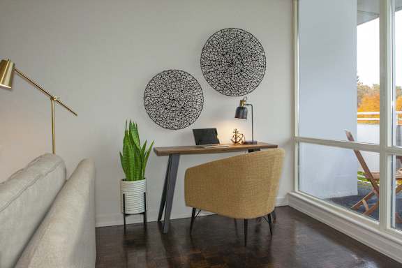 a workspace with a desk and a chair in a living room