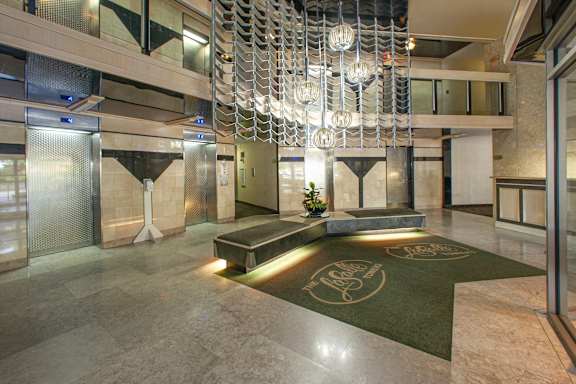a large lobby with a seating area and a chandelier