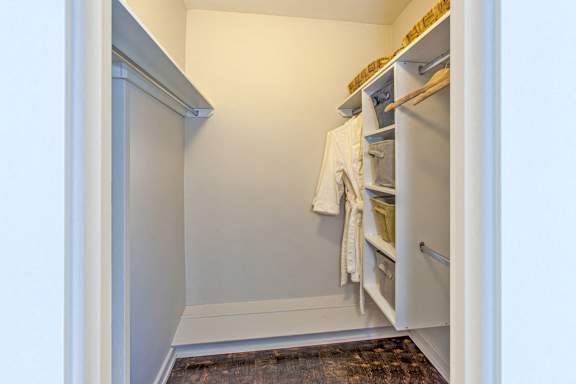 a small walk in closet in a home with a door open