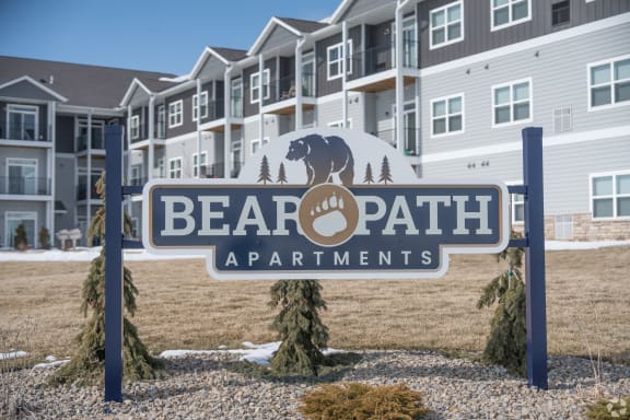 a bear path apartments sign in front of an apartment building