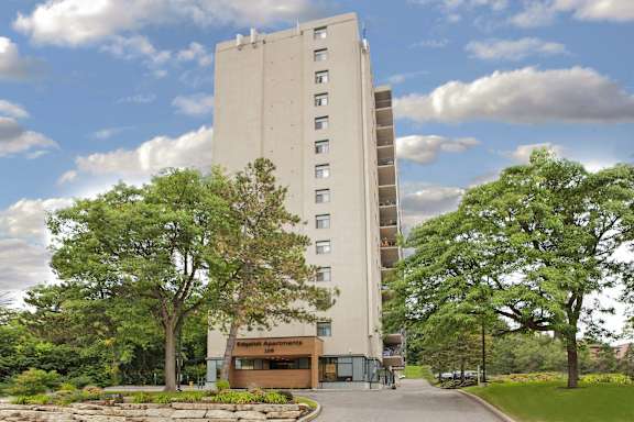 a tall building with trees in front of it