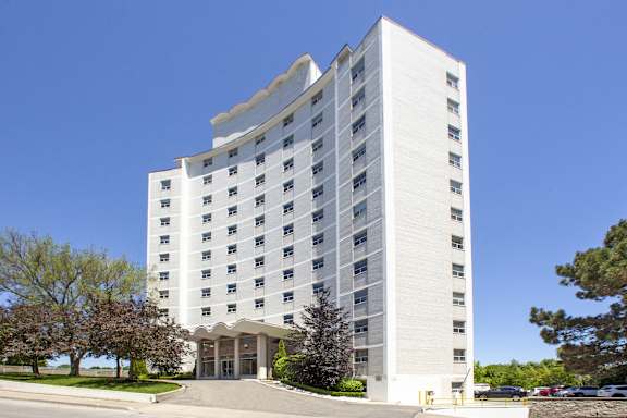 a tall white building with a street in front of it
