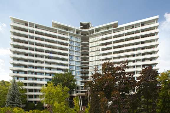 a tall building with trees in front of it