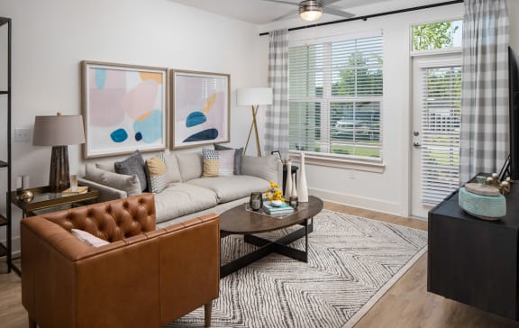 a living room with a couch and a coffee table at The Quincy Apartments in Acworth, GA 30102