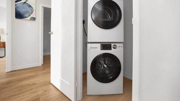 a white washer and dryer in a white room