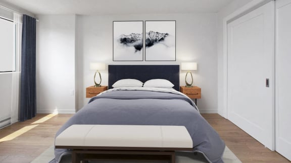 a bedroom with a bed and two paintings on the wall