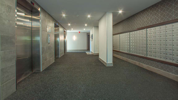 a hallway with lockers and doors in a building