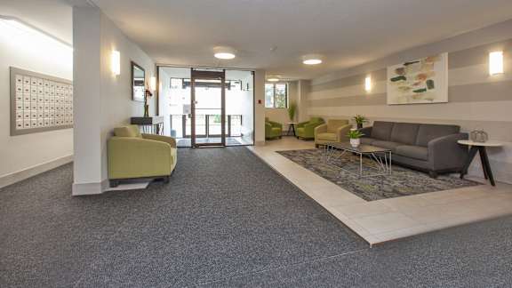 a living room with couches and chairs and a rug