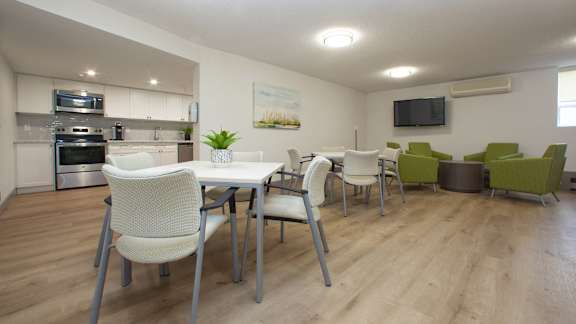 a dining room with a table and chairs and a kitchen