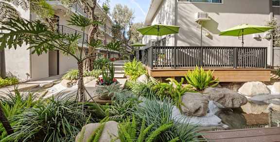 a swimming pool with palm trees and a resort style pool at Villa Vicente, Los Angeles, CA