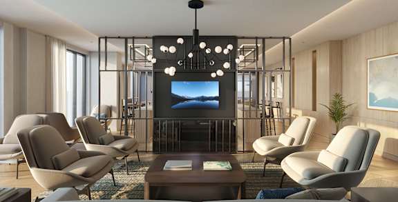 A modern living room with a large screen TV and comfortable seating.