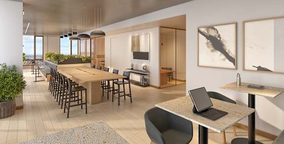 A modern dining area with a laptop on the table.