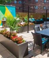 a patio with a table and chairs and a large colorful mural