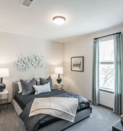 a bedroom with a large bed and a window at Village at Westland Cove Apartments, Knoxville, TN, 37922