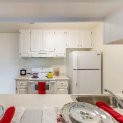 A kitchen with a white refrigerator and white cabinets. at Vintage Pointe Apartments, California, 94928