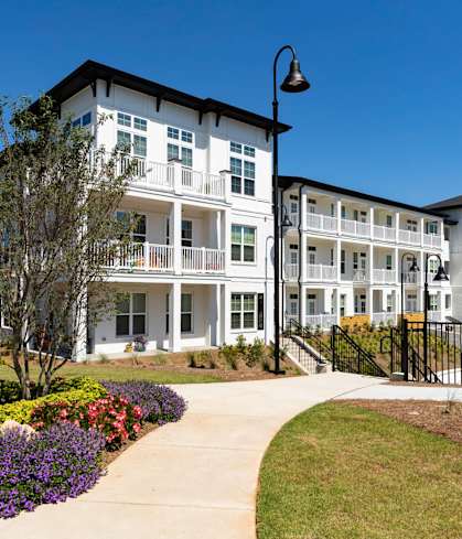 a sidewalk in front of an apartment building at The Quincy Apartments in Acworth,  30102