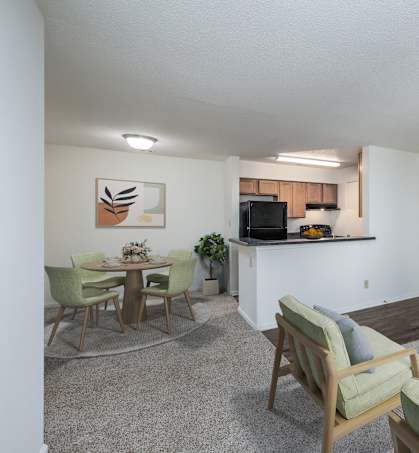 A living room with a white couch, a coffee table, and a television.