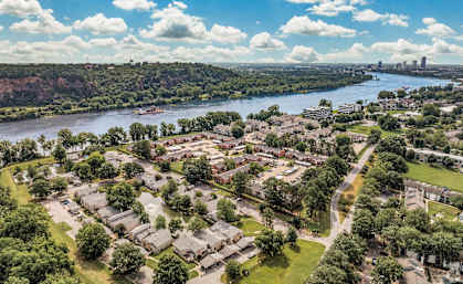an aerial view of a city with a river and trees at Brightwaters Apartments, Little Rock, Arkansas
