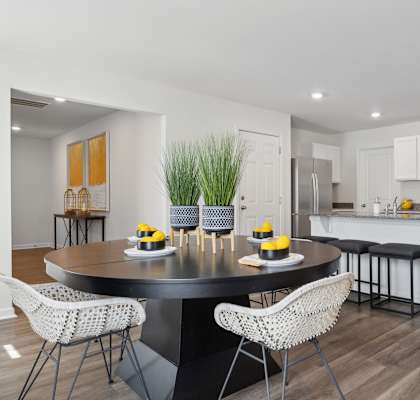 an open kitchen and dining room with a table and chairs