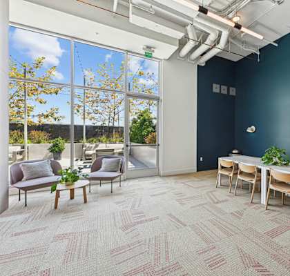 A room with a long table and chairs with a view of the outside.at 2221 S Western, Los Angeles, CA 90018
