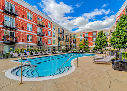 our apartments offer a swimming pool with lounge chairs at Avant at the Arboretum, Lisle, IL