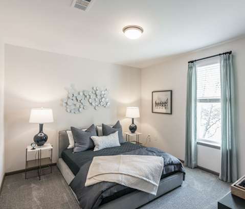 a bedroom with a large bed and a window at Village at Westland Cove Apartments, Tennessee