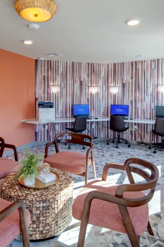 A reception area with a piano and chairs.