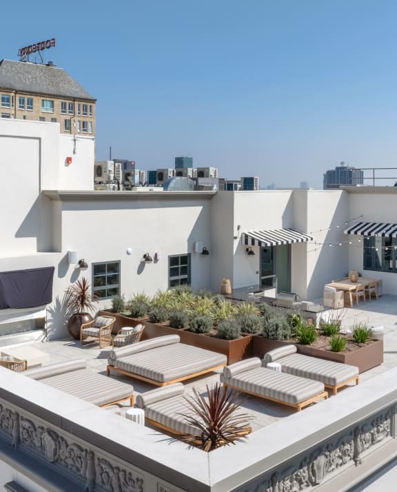 a roof terrace with furniture and a city in the background The Baxter in Los Angeles, CA 90028