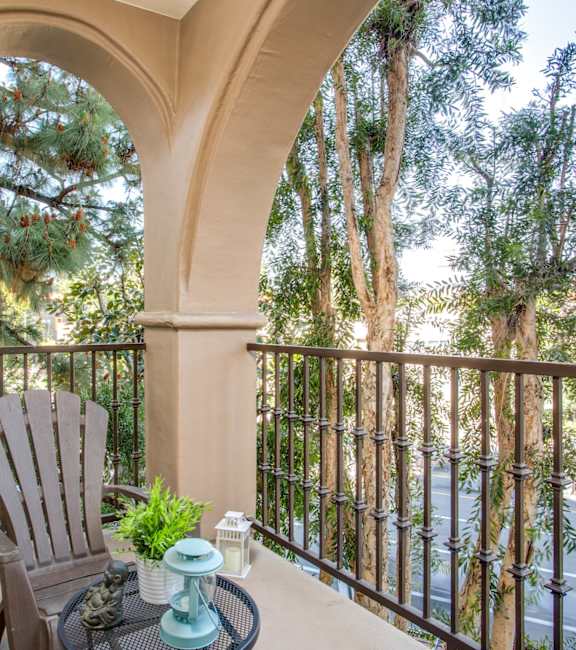 a balcony with a chair and a view of a tree at L'Estancia, Studio City, CA, 91604