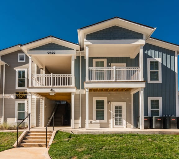 an apartment building with stairs and a sidewalk in front of it at Village at Westland Cove Apartments, Tennessee