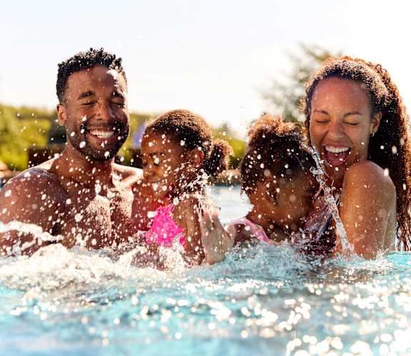a family playing in the swimming pool at Pavilion Luxury Apartments, Riverview, FL, Florida, 33578