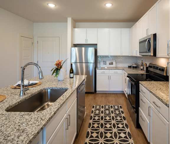 Open Kitchen with an Island at The Quincy Apartments in Acworth, GA
