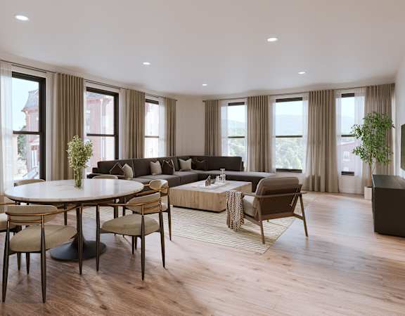 A modern living room with a large table and chairs.
