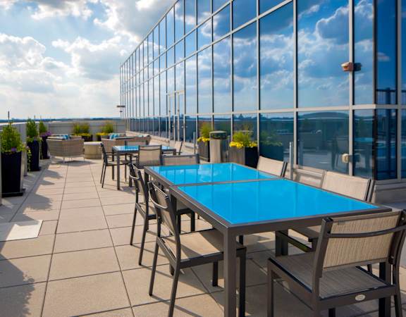 a terrace with tables and chairs on top of a building at 220 Twentieth Street, Virginia, 22202