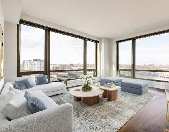 a living room with couches and a coffee table in front of windows at The Bartlett in Arlington, VA 22202